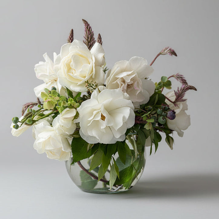 Bouquet of white flowers in a clear vase 